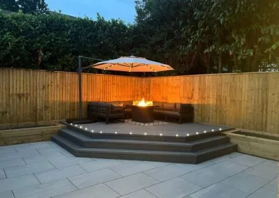 Evening lighting around a raised patio seating area