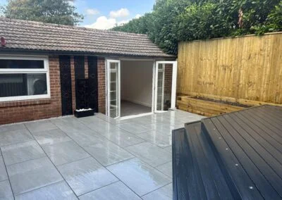 Patio and decking beside an outdoor room