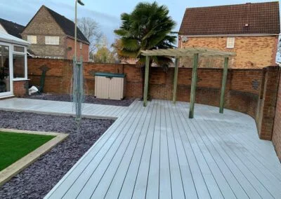 Decking around a lawn and timber shelter