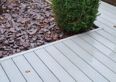 Decking edge beside a mulched planting bed
